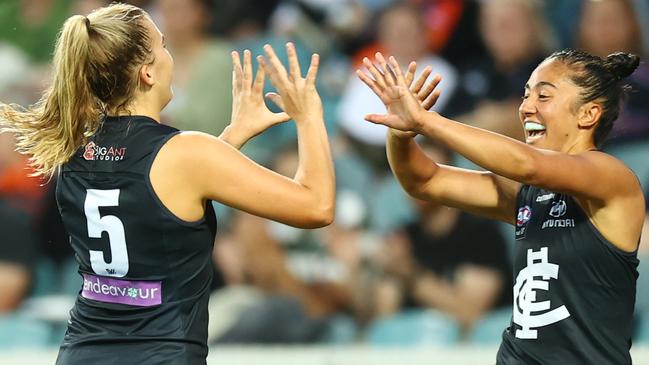 CANBERRA, AUSTRALIA - FEBRUARY 27: Abbie McKay of Carlton celebrates her goal with team mate Darcy Vescio during the round eight AFLW match between the Greater Western Sydney Giants and the Carlton Blues at Manuka Oval on February 27, 2022 in Canberra, Australia. (Photo by Mark Nolan/Getty Images)