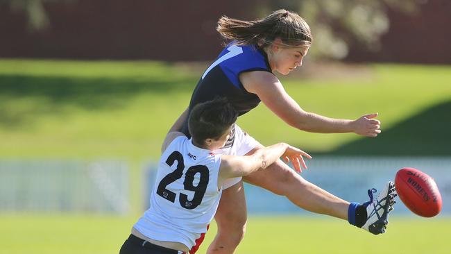 Madeline Keryk of Melbourne Uni is tackled by Shark Alex Whitehead during the VFL Women's match  at North Port Oval.  Picture: Hamish Blair