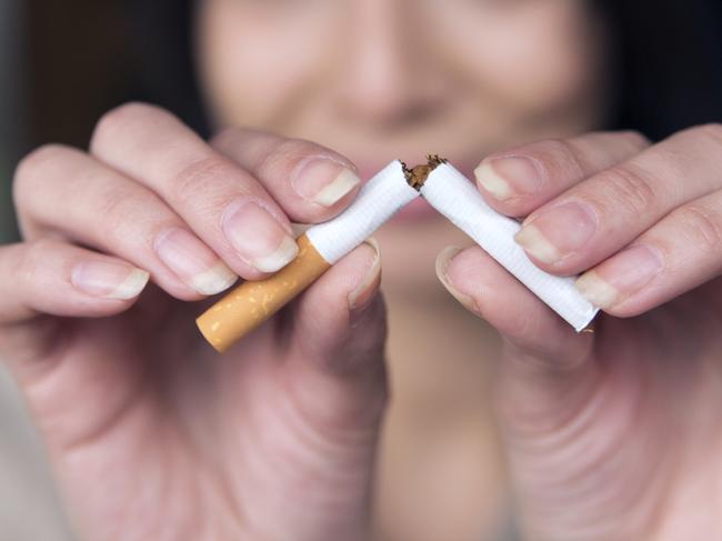 beautiful young woman breaks a cigarette as a gesture for quit smokingPicture: istock