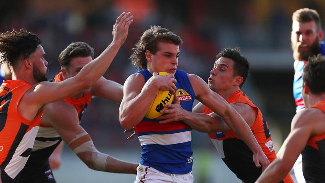 Western Bulldogs young gun Bailey Smith tries to burst through a Josh Kelly tackle. Picture: Mark Metcalfe/Getty Images.