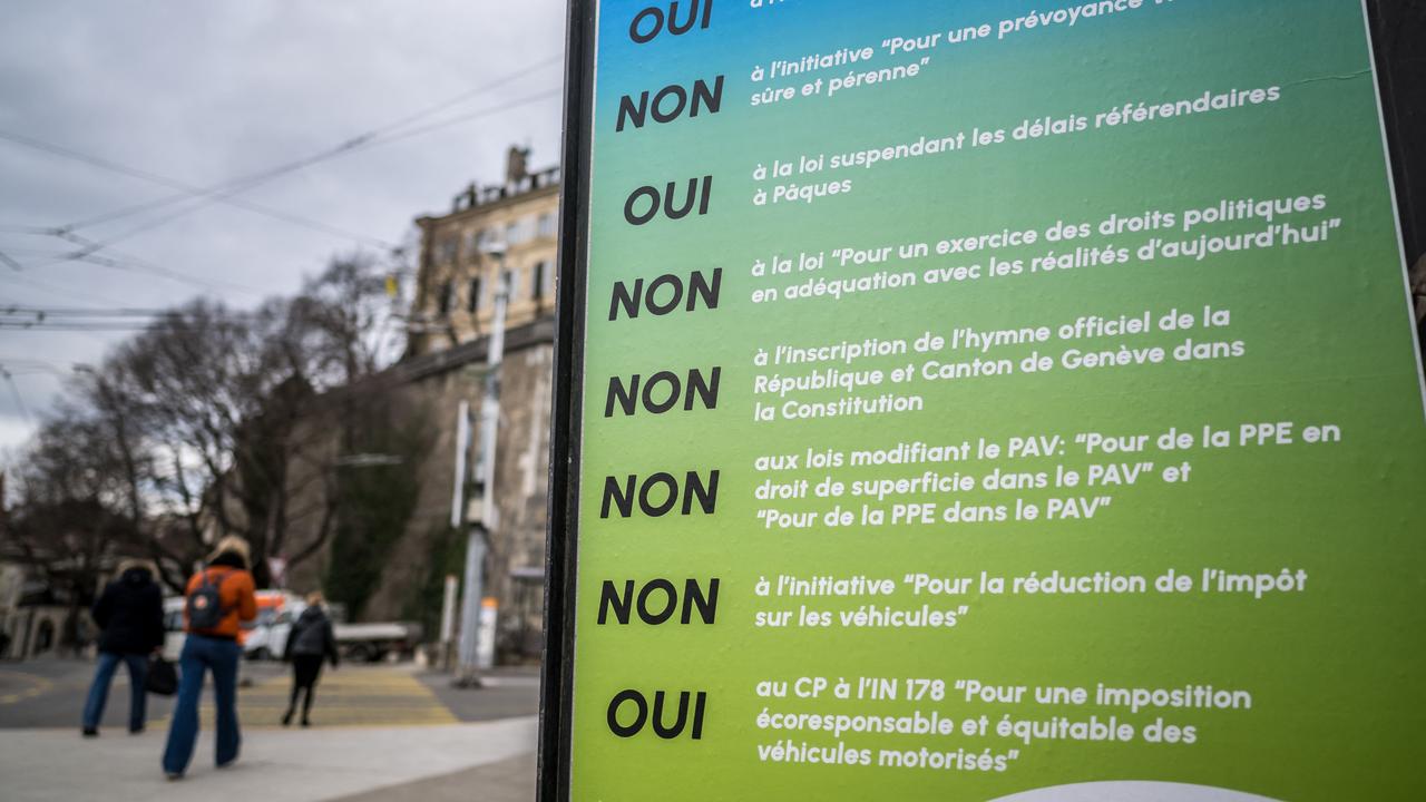 Ms Chase said the Swiss were ‘really serious’ about democracy. Pictured here is pedestrians walking past a referendum poster earlier this year in Geneva. Picture: Fabrice Coffrini / AFP