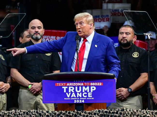 TOPSHOT - Former US President and Republican presidential candidate Donald Trump speaks alongside National Border Patrol Union members after they endorsed Trump, during a campaign rally at Findlay Toyota Arena in Prescott Valley, Arizona, on October 13, 2024. (Photo by Caitlin O'Hara / AFP)