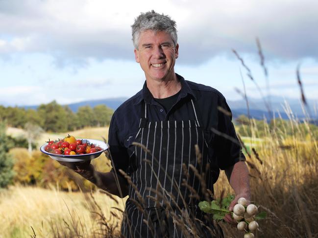 Matthew Evans holding a plate of garden tomatoes and Japanese turnips harvested in the rich soils on his Glaziers Bay property. Picture: LUKE BOWDEN