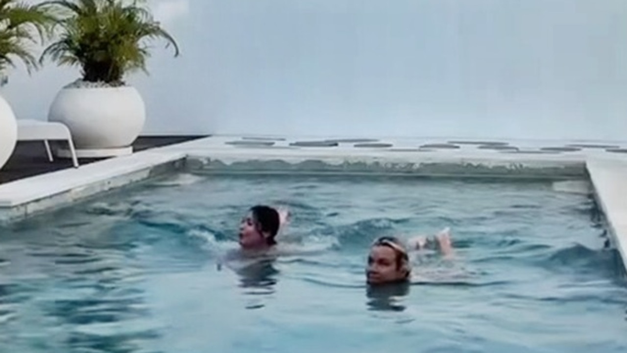 Bella shrieked when she noticed a man standing by the side of the pool.