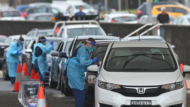 Health workers perform COVID-19 tests at the drive-through testing centre at Bondi Beach.