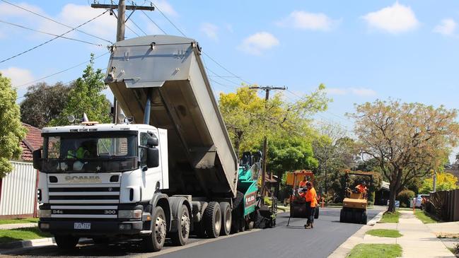 Workers lay the recycled asphalt in Watsonia.