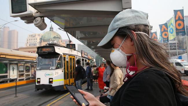 Face masks have become a common sight on Melbourne streets this week. Picture: AAP Image/David Crosling