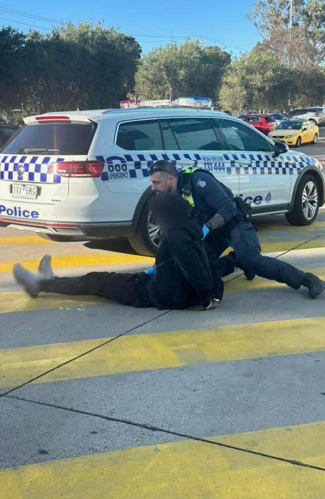 Police arrest a man outside Northland. Picture: Facebook