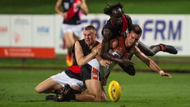 Matt Ryan takes a heavy tackle as the NTFL Buffaloes' mens side beat the Essendon Bombers. Picture: Pema Tamang Pakhrin