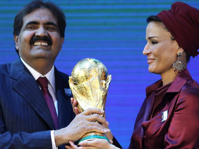 Qatar's Emir Sheikh Hamad bin Khalifa al-Thani and his wife Sheikha Moza hold the World Cup trophy after Qatar was chosen to host the 2022 World Cup at the FIFA headquarters in Zurich on December 2, 2010. Qatar became the first Arab, Middle Eastern or Muslim country to be awarded the right to stage football's World Cup. AFP PHOTO/KARIM JAAFAR