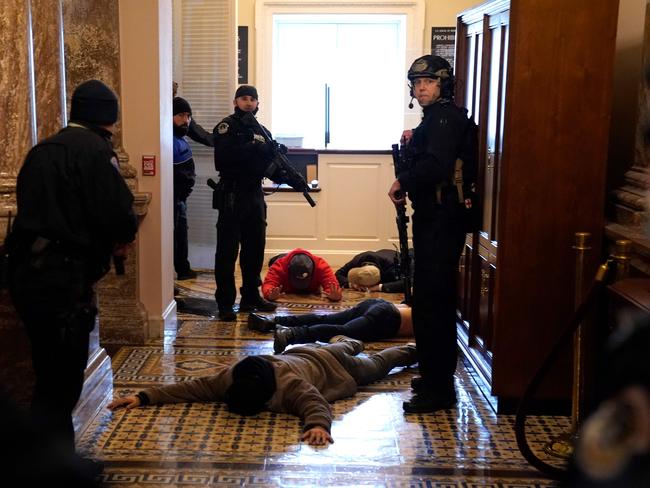 US Capitol Police stand detain protesters outside of the House Chamber. Picture: AFP