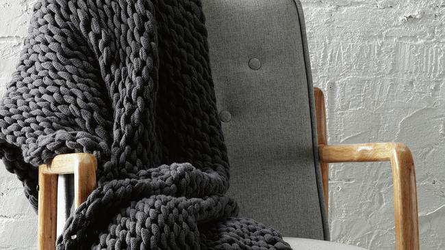 The chunky knit throw comes in white, grey and charcoal.