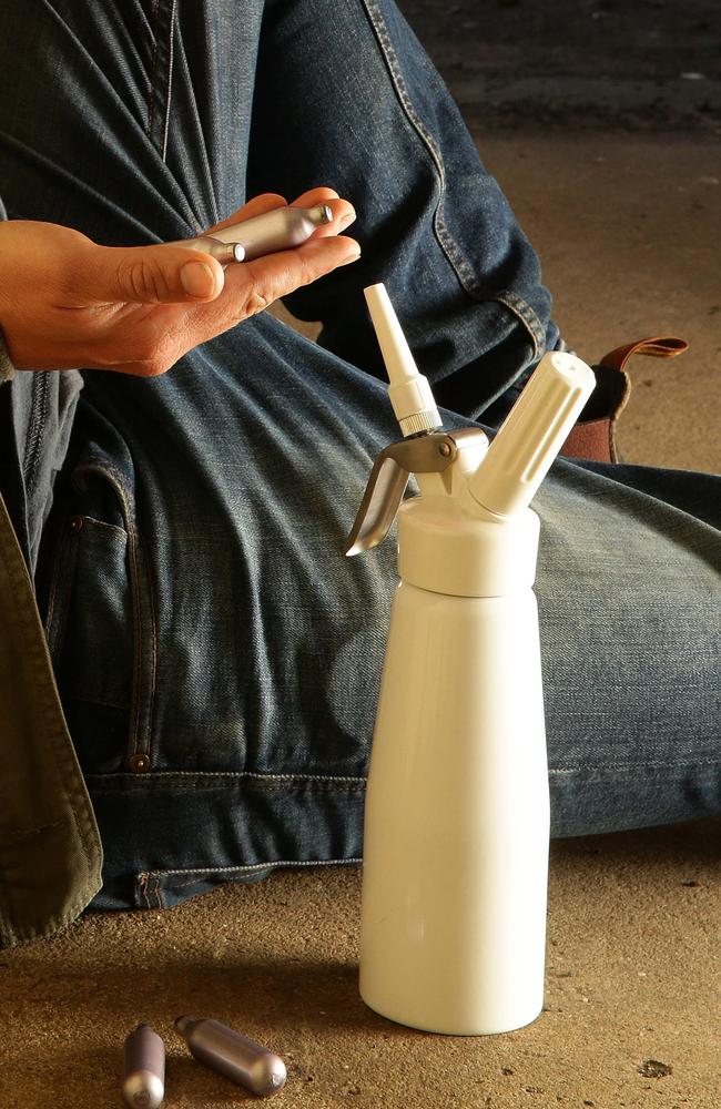 Silver canisters filled with nitrous oxide, known as nangs, are placed into a device, shown above, to be inhaled. Picture: Peter Ristevski