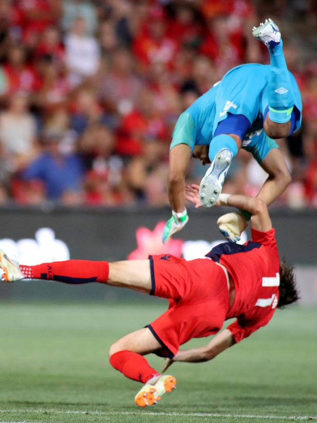 Jamie Young of the Roar clashes with Craig Goodwin of United at Coopers Stadium. Picture: AAP Image/Kelly Barnes