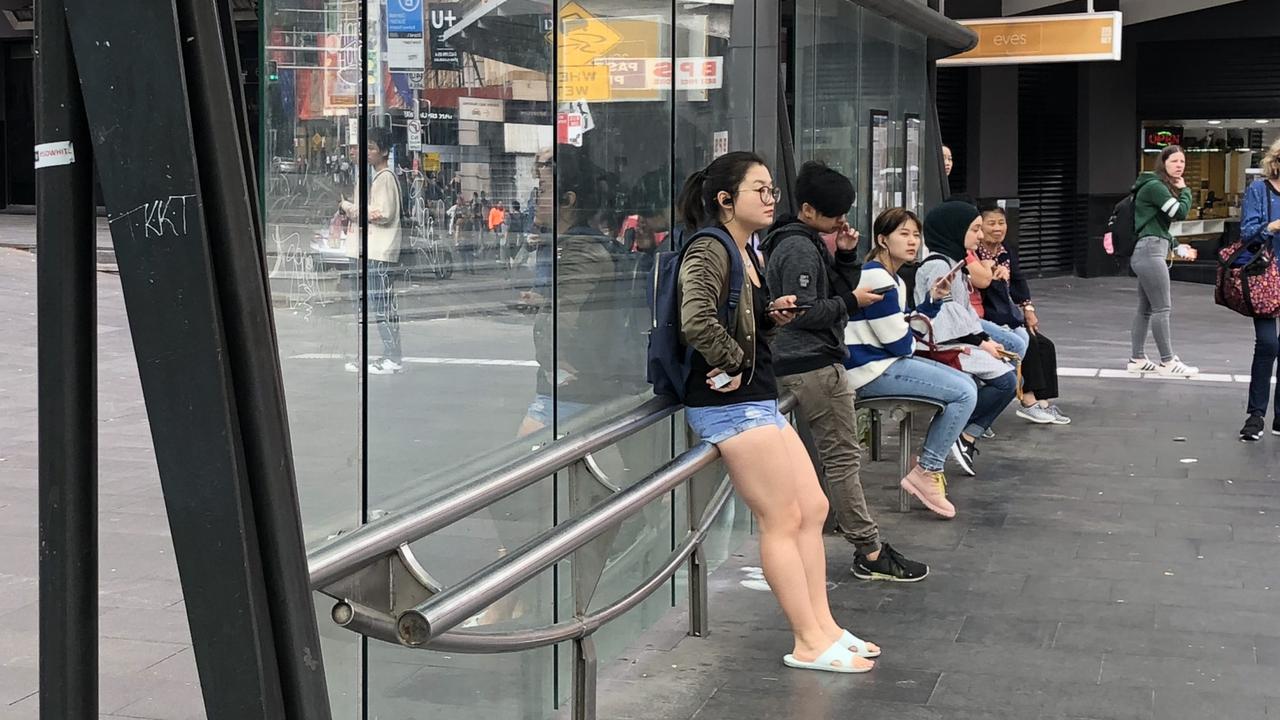 Benches replaced at a bus stop by metal bars.