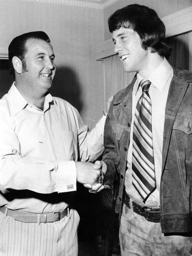 Woodville footballer Glynn Hewitt (right) shakes hands with his dad Max Hewitt.