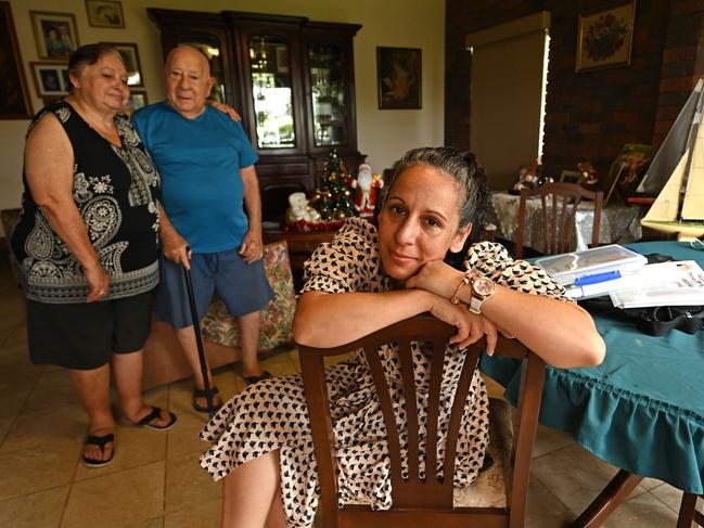 07/01/2022:  Mina Cullen, 41 (who has to social distance from her parents at the moment) who oversees the health of her parents  parents Eva and Nicholas Comino, aged 72 and 82, at their home in Bethania, Brisbane. The old couple lined up in a drive-thru testing line at 2:30am  in Brisbane's south on Thursday and were still second in line. Mr Comino, who is in remission for leukaemia and has asbestosis and diabetes, was forced to wait hours without his sleep apnea machine following recent back surgery.   Lyndon Mechielsen/The Australian