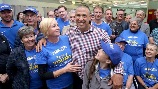 Terry Young (centre) on the campaign trail posing at the Caboolture Show Grounds. (Image AAP/Steve Pohlner)