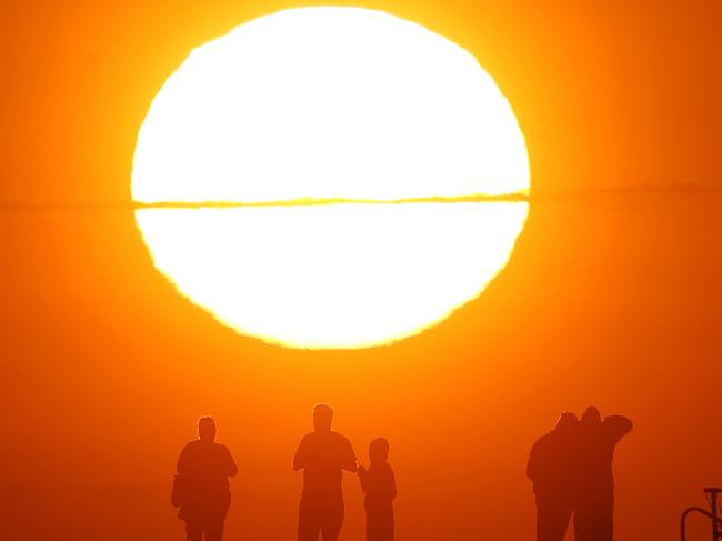 6.08AM The sun rises over Altona Pier as Melbourne prepares for a scorcher on a day of severe and extreme fire danger warnings. Picture: Mark Stewart