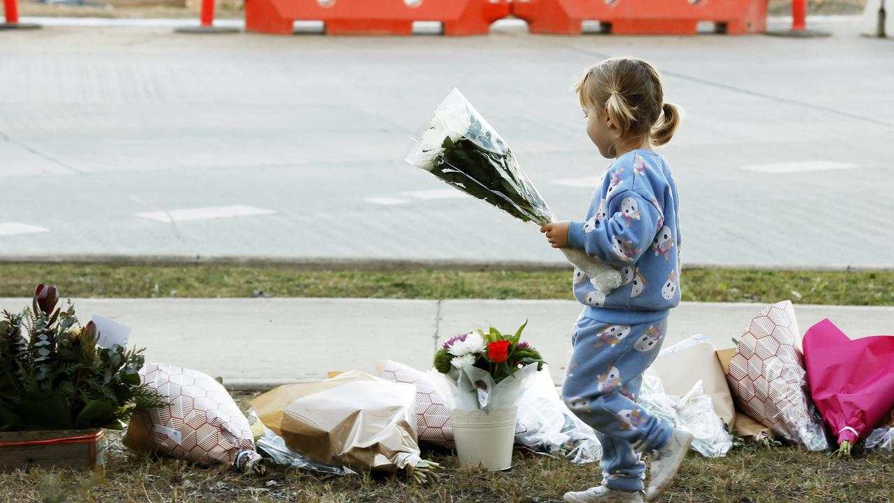 People leaving floral tributes near the scene of the horrific Hunter bus crash, which killed 10 people and injured 25 others at Greta in the Hunter wine country. Picture: Jonathan Ng