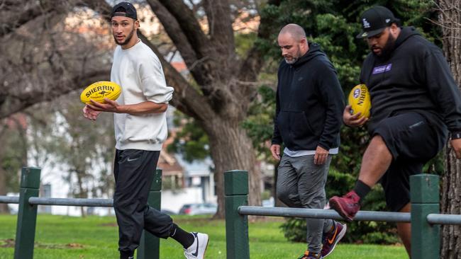 Simmons and his entourage at Yarra Park. Picture: Jake Nowakowski