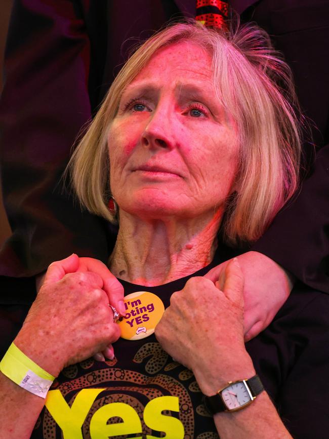 A woman looks on during a live telecast of Anthony Albanese’s speech