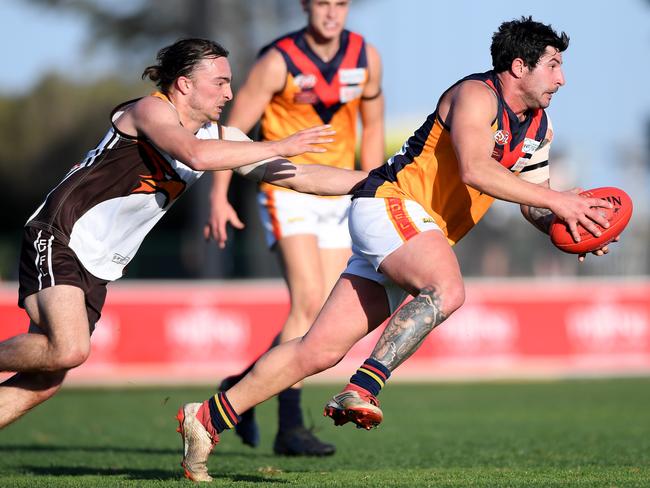 Craigieburn’s Josh Vilinskis tries to stop East Keilor’s Con Grampsas. Picture: Andy Brownbill