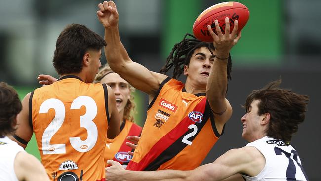 MELBOURNE, AUSTRALIA - APRIL 01: Isaac Kako of the Cannons handballs under pressure during the round two Coates Talent League Boys match between Calder Cannons and Sandringham Dragons at Highgate Recreation Reserve on April 01, 2023 in Melbourne, Australia. (Photo by Daniel Pockett/AFL Photos/via Getty Images)