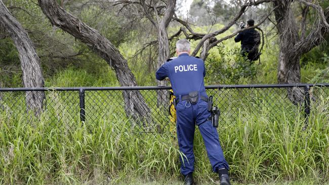 Officers photograph the scene. Picture: Damian Shaw