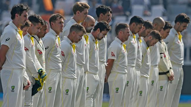 Australia's players observe a minute silence and pay their respects to Warne before Day 2 of the first Test against Pakistan. (Photo by Aamir QURESHI / AFP)