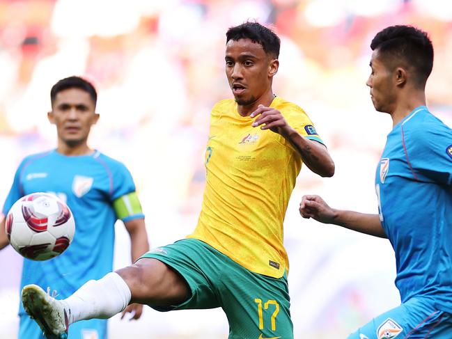 DOHA, QATAR - JANUARY 13: Keanu Baccus of Australia is challenged by Lalengmawia Apuia of India during the AFC Asian Cup Group B match between Australia and India at Ahmad Bin Ali Stadium on January 13, 2024 in Doha, Qatar. (Photo by Robert Cianflone/Getty Images)