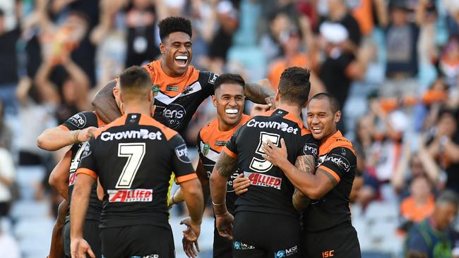 The Tigers celebrate their win over the Roosters during the Round 1 NRL match between the Wests Tigers and the Sydney Roosters at ANZ Stadium in Sydney, Saturday, March 10, 2018. (AAP Image/Dean Lewins) NO ARCHIVING, EDITORIAL USE ONLY