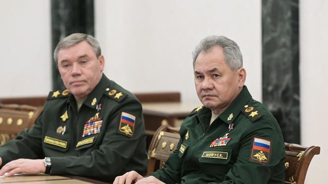 Russian Defence Minister Sergei Shoigu (R) and chief of the general staff Valery Gerasimov attend a meeting with Vladimir Putin. Picture: AFP.