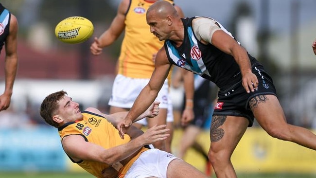 Mark Keane of the Crows tackled by Willie Rioli of the Power as Sam Powell-Pepper cannons into him. Picture: Mark Brake/Getty Images.