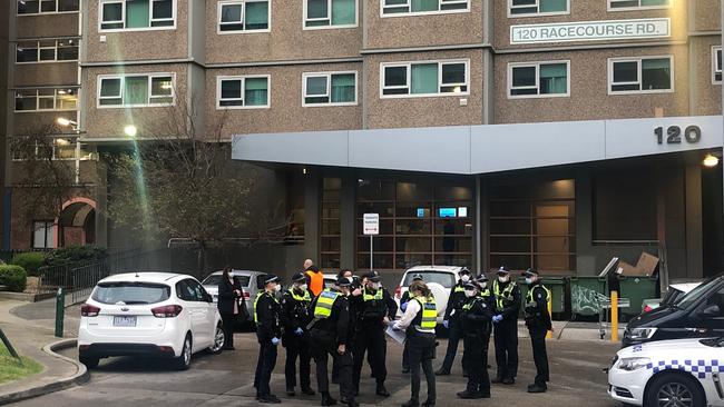 Police arrive at 120 Flemington Rd this afternoon ahead of the lockdown. Picture: Ian Royall