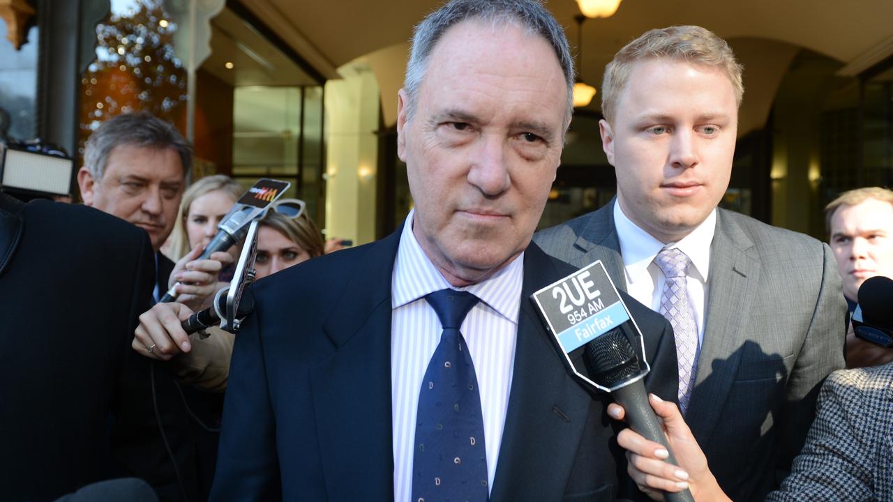 Disgraced Hey Dad star Robert Hughes, (above, centre) leaving court during his 2013 trial, renounced his Australian citizenship but failed to get parole. Picture: Dean Lewins