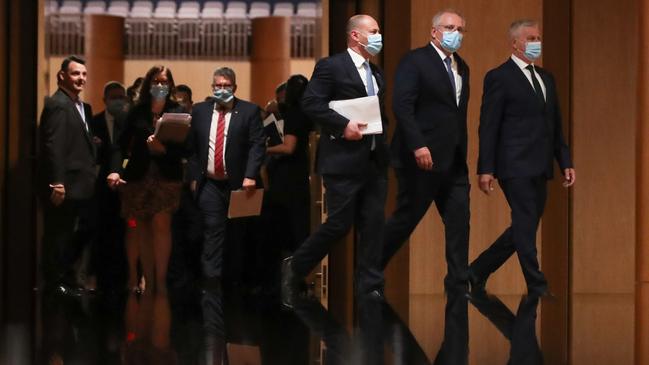 Josh Frydenberg, Scott Morrison and Michael McCormack make their way through the House of Representatives for the Treasurer’s budget speech. Picture: Alex Ellinghausen