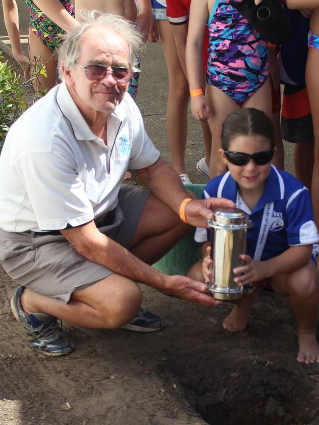 The Hills Swimming and Life Saving Club's longest serving active member, Graham Taylor, and its youngest, Rebecca Hogan, placed a time capsule into the ground at the club's 50th anniversary celebrations on February 12.