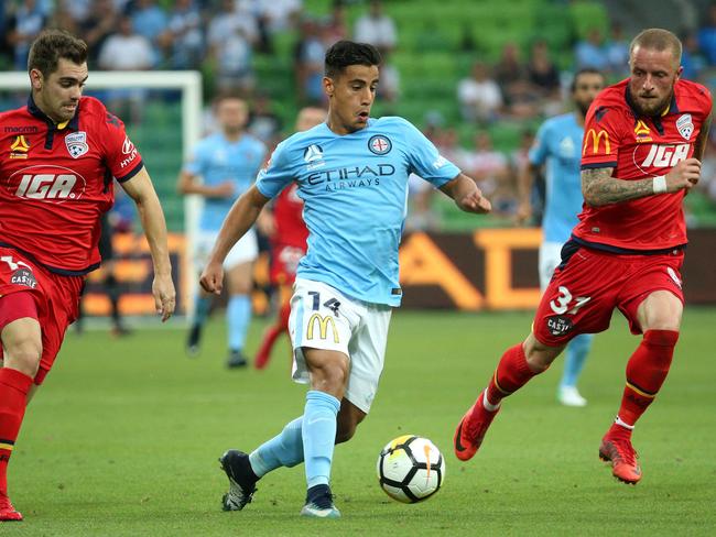 Daniel Arzani toys with Adelaide defenders.