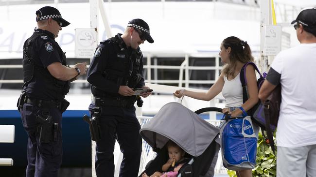 In Queensland, police check people boarding the Stradbroke Island Ferry, with only residents allowed to go to the island. Picture: Attila Csaszar/AAP