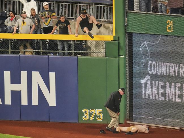 A fan lies on the warning track after the horror fall. (AP Photo/Gene J. Puskar)