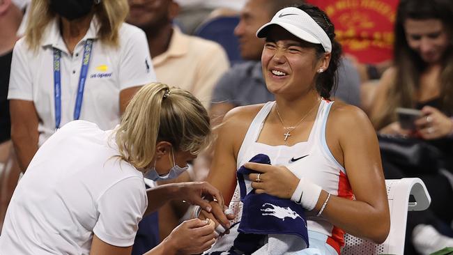 Emma Raducanu of Great Britain receives medical attention. Photo by Julian Finney/Getty Images