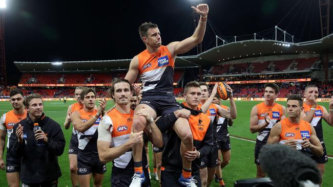 GWS teammates chair Brett Deledio off after the match. Picture: Phil Hillyard