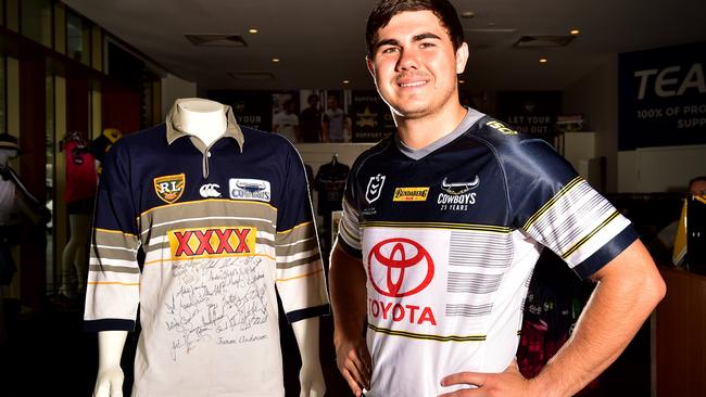 North Queensland Cowboys player Jake Clifford showcasing the new 2020 season jersey next to the 1995 jersey which inspired the design. Picture: Alix Sweeney