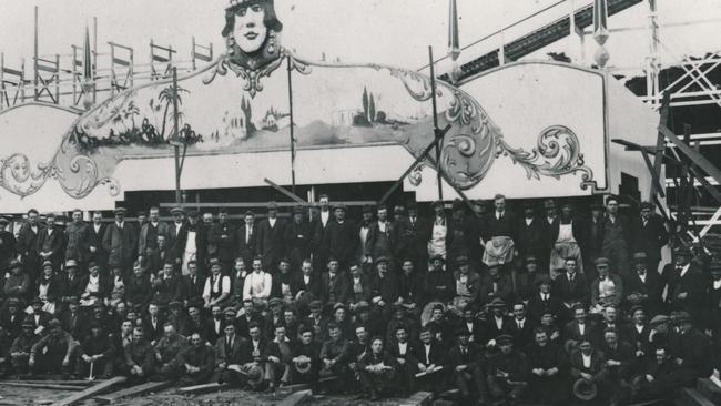 The construction crew pose for a group photo in the park.