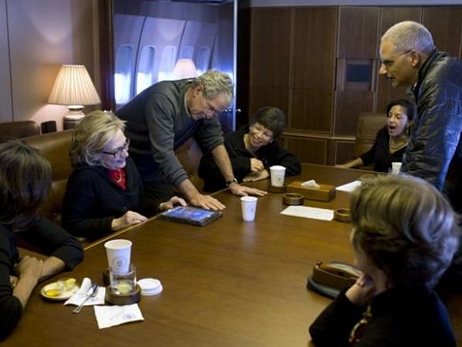 Former US President George Bush shows off his art to the group. Picture: Pete Souza / Official White House Photo