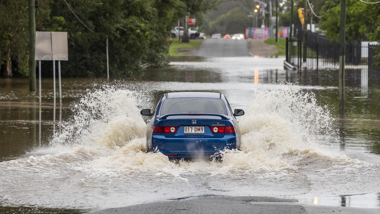 A motorist tries to make it through floodwaters at Carina in Brisbane’s east on Friday morning. Picture: Richard Walker