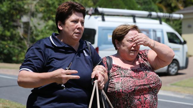 Family and friends arrive outside a home in The Gap after hearing the news a relative was found deceased this morning. Picture: Jack Tran