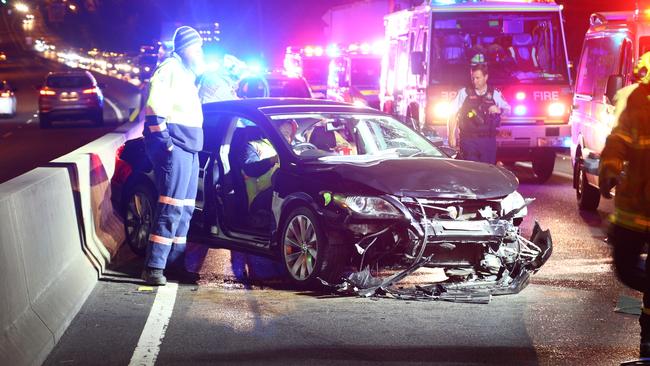 A devastating smash on Centenary Drive after a driver drifted into the center concrete barrier and became trapped for 40 minutes. Picture: Dean Asher/Top Notch