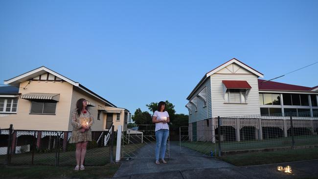 People stand outside their homes at dawn to commemorate Anzac Day in Brisbane, Saturday, April 25, 2019. Anzac Day is a national day of remembrance to commemorate the service and sacrifice of Australian and New Zealand service men and women. Due to COVID-19 restrictions marches and commemorative services have been banned for the first time in more than a century. (AAP Image/Dan Peled) NO ARCHIVING
